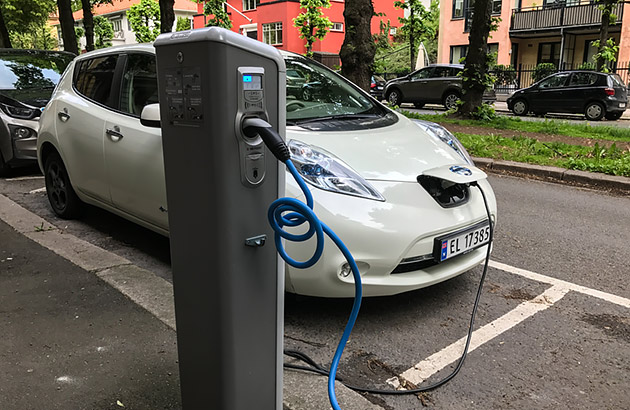 An electric car being charged on a street in Oslo, Norway