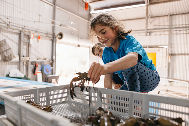 Girl picking up a yabby