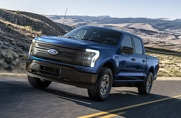 A Ford F150 Lightning electric ute on a country road