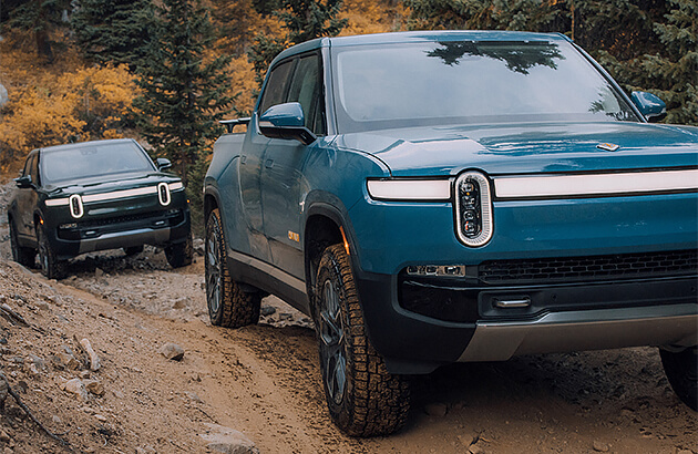 A Rivian electric ute on a muddy track