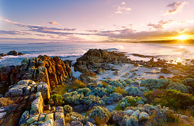 A beach on Tasmania's Bay of Fires at sunset