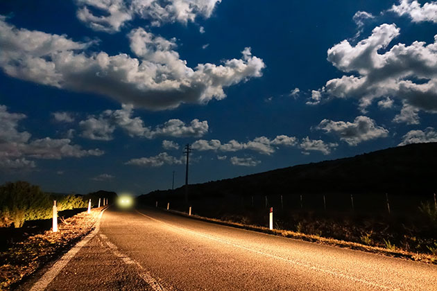 Car headlights on a country road