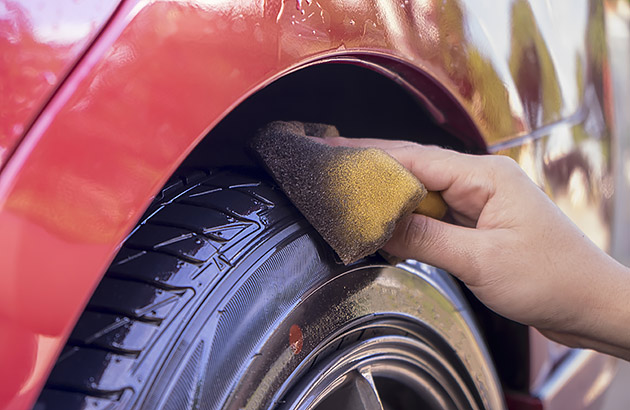 Using tyre cleaning foam on a car tyre