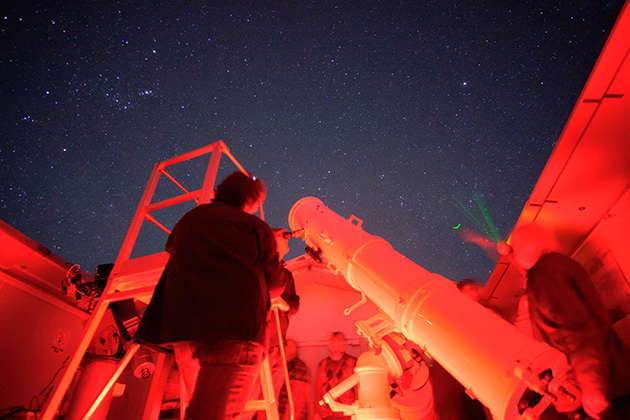 Person using telescope at night