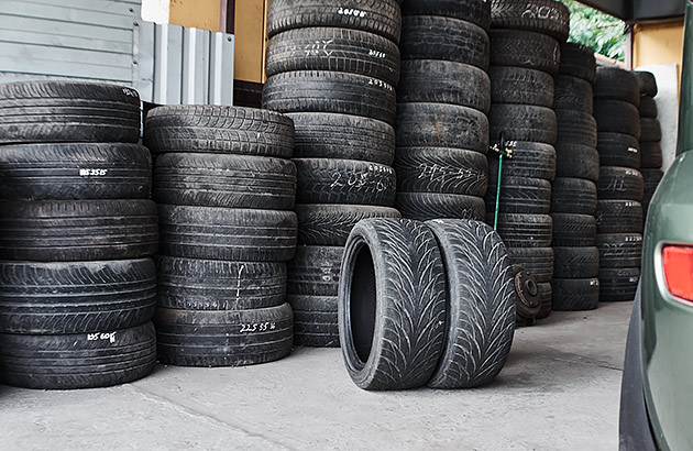 Columns of old car tyres in a workshop