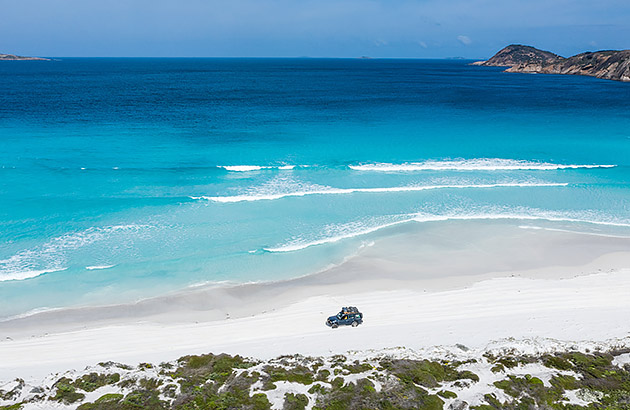 A 4WD on a white sand beach in Esperance