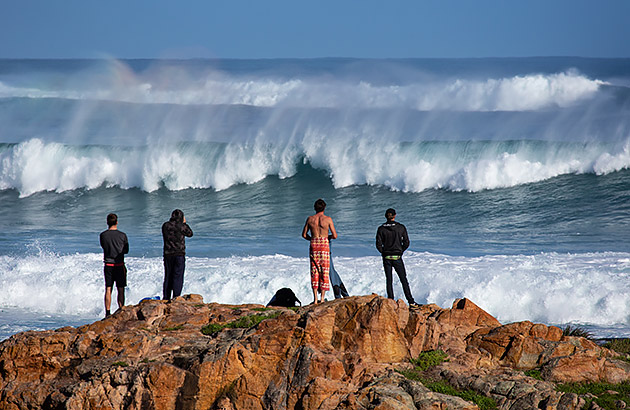 Surfers looking out at the waves in Gracetown