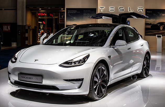 White Tesla Model 3 car in a showroom