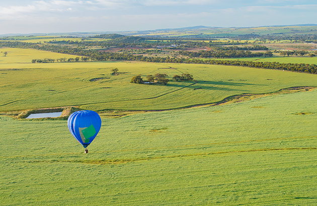 A blue hot air balloon over the Avon Valley