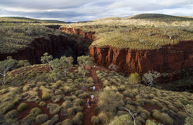 An aerial shot of Karijini National Park with a family walking