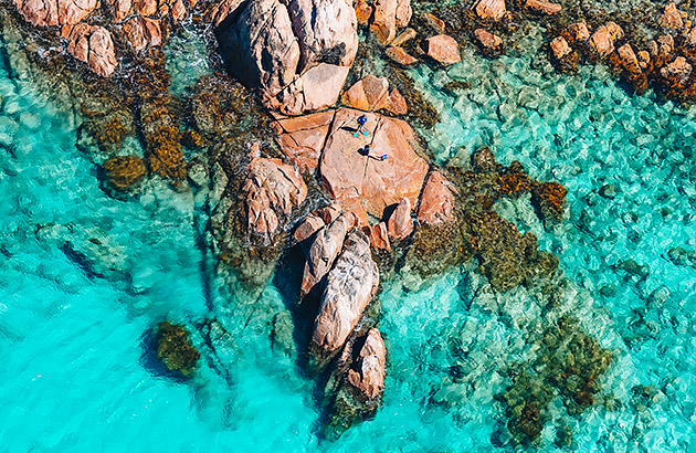 Two people snorkelling off rocks near Margaret River