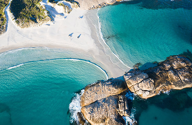 An aerial photo of rocks and beach at Wylie Bay Esperance