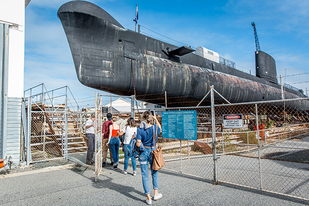 People standing outside submarine