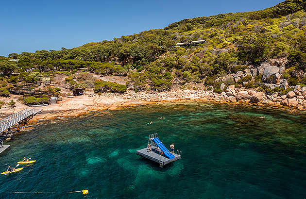 A pontoon with a slide in the water near the beach at Woody Island