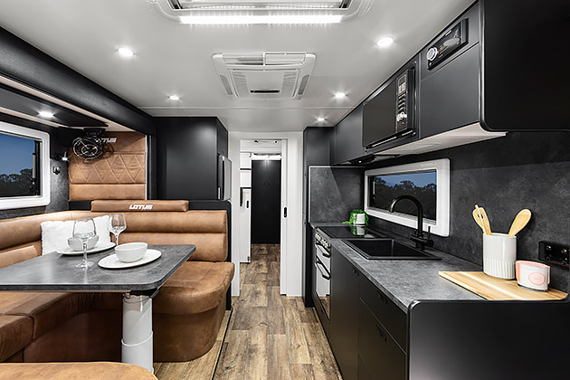 The interior of a Lotus caravan showing the kitchen and lounge area