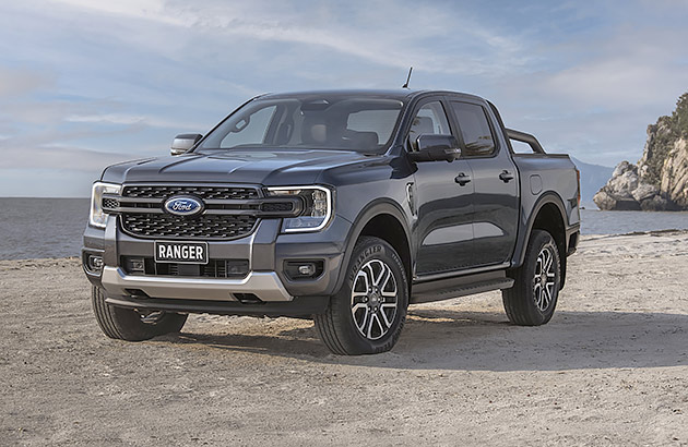 A grey Ford Ranger parked on a beach