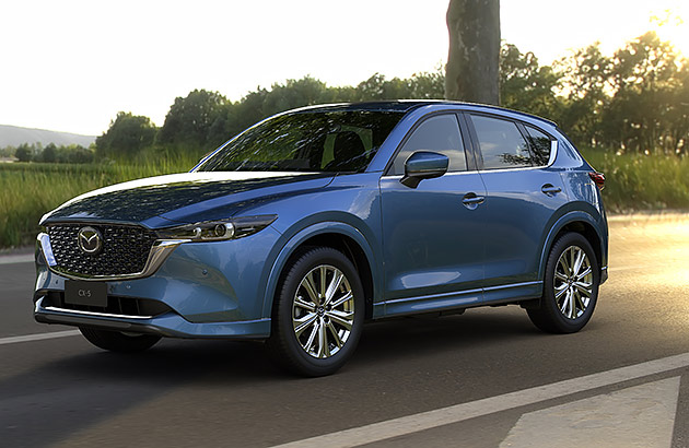 A Mazda CX-5 driving on a country road