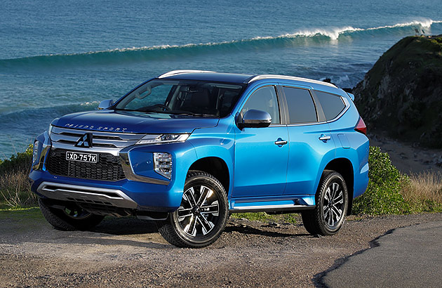 A blue Mitsubishi Pajero Sport parked near a beach