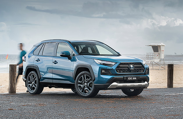 A blue Toyota RAV4 parked by the beach