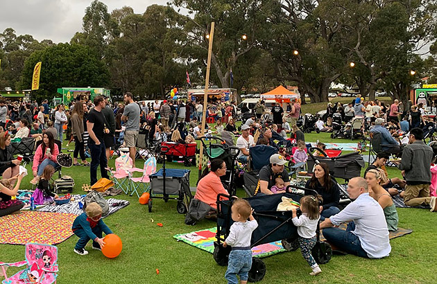 Groups of people sitting in a parkland setting