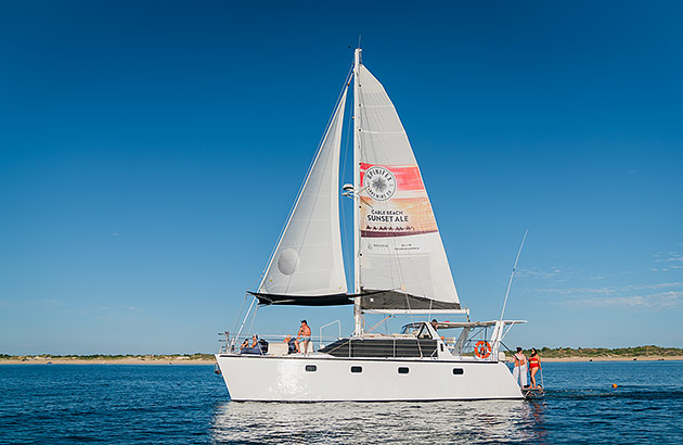 A yacht sailing on calm water on a sunny day