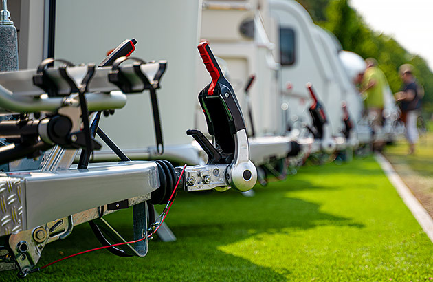 A row of caravans being inspected