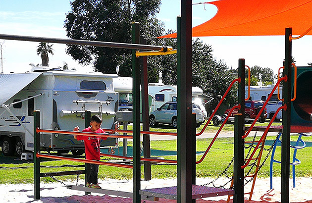 A small boy in caravan park playground