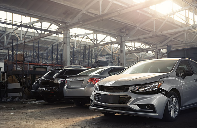 Wrecked cars inside a dark warehouse