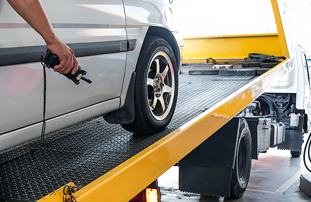 A car being repossessed and loaded onto a tow truck