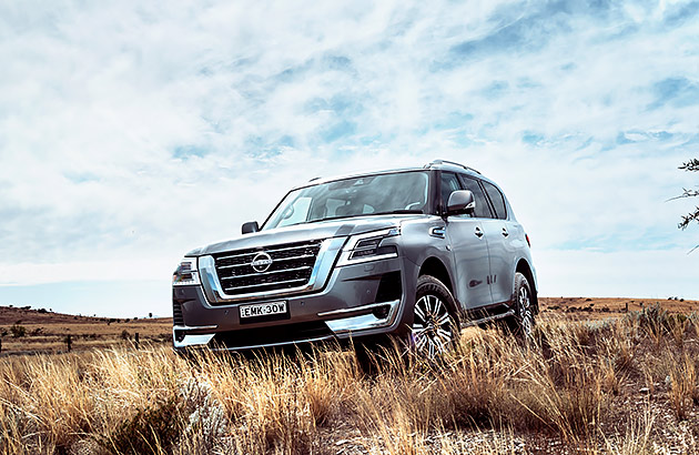 A silver Nissan Patrol on a dirt track