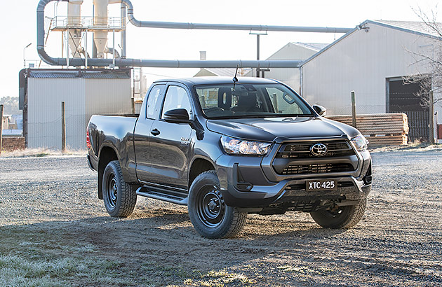 A dark grey Toyota Hilux SR on a work site