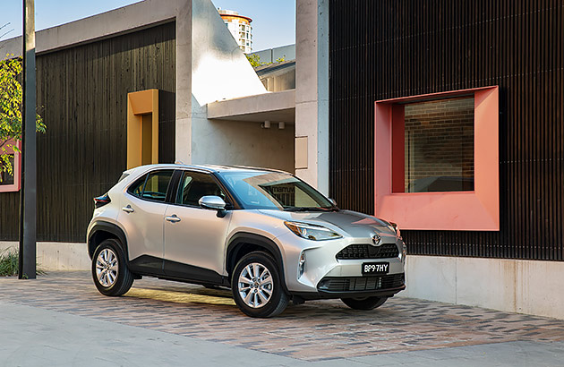 A silver Toyota Yaris Cross GX parked on a city street