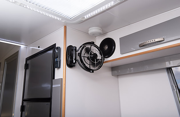 A fan mounted on the wall of a caravan