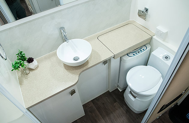 A washing machine in a caravan bathroom