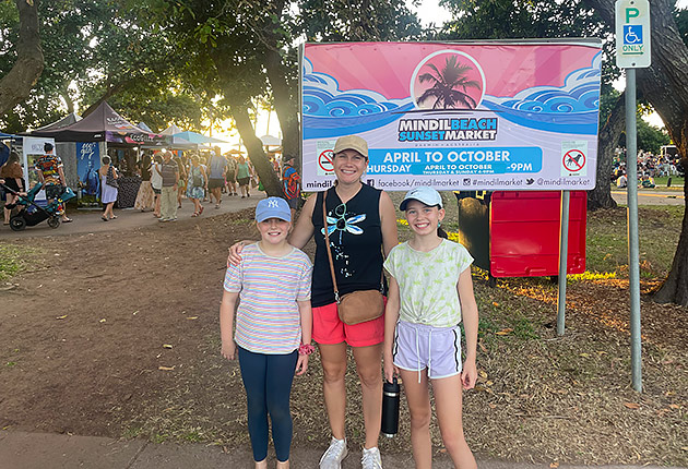 The Morrell family standing in front of the Mindil Markets sign in Darwin