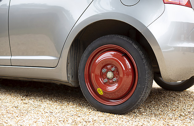 A close up of a space saver tyre on a car