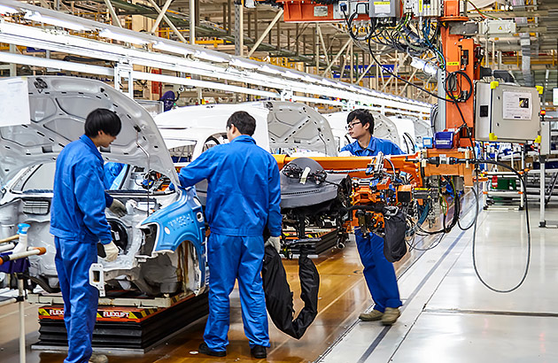 Workers on a production line in a car factory in Shanghai