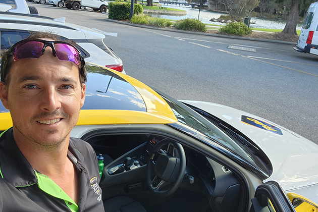 Man taking a selfie in front of a Polestar Electric Car