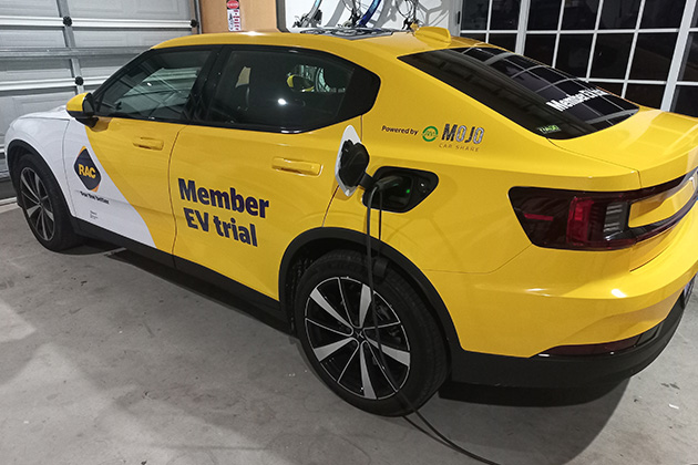 A Polestar 2 EV charging in a garage