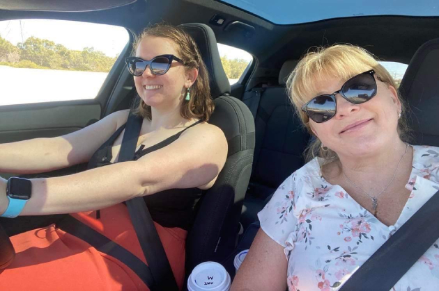 Mother and daughter driving selfie inside Polestar 2 electric vehicle