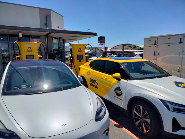 Polestar 2 electric car charging at electric charging station beside a Tesla