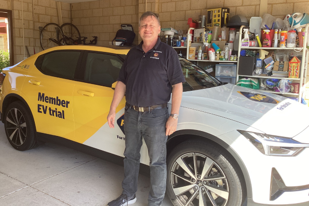 Man standing in front of yellow Polestar 2 electric car parked in garage