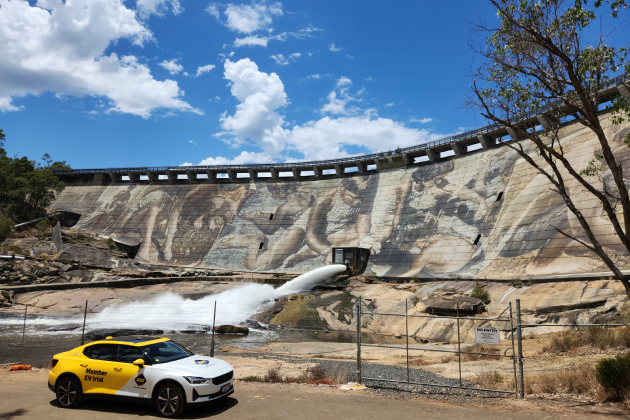 Yellow Polestar 2 electric car parked in front of Wellington Dam mural in Western Australia