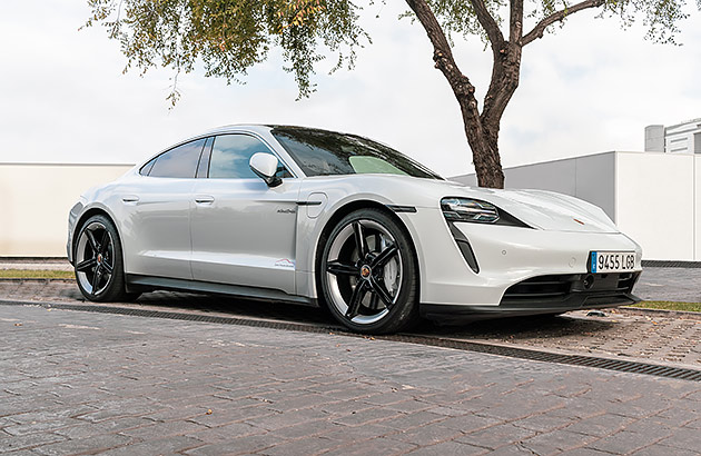 A white Porche Taycan on a city street