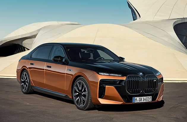 A brown BMW i7 outside a modern domed building