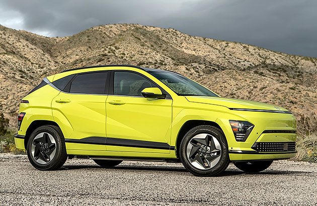 A bright green Hyundai Kona Electric with barren mountains in the background
