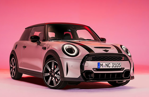 A Mini Cooper S illuminated by pink light