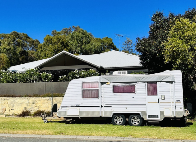 Caravan parked outside house on the verge