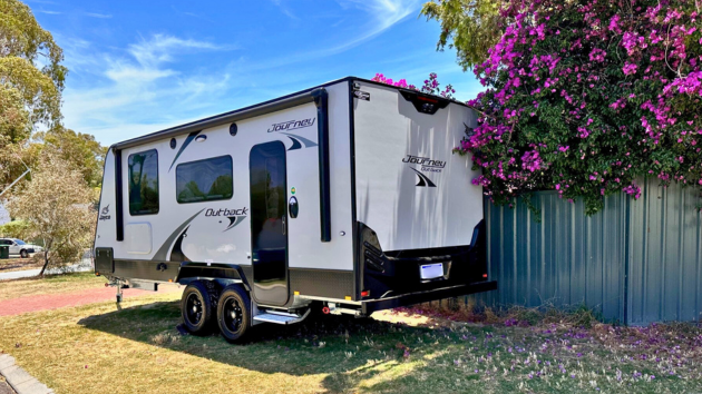 Caravan parked outside house on verge