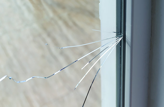 Cracked window glass seen from inside a home